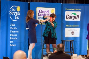 Co-host Julie McDonough helped speaker Colleen Needles Steward draw a winner for the Bucket of Good Will fundraiser.